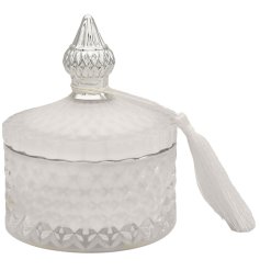 A luxurious glass candle in white with ridged detailing