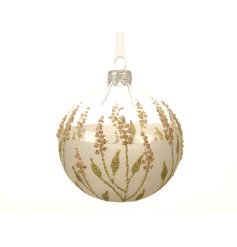 A unique glass bauble decorated with glitter and eco dried flowers.