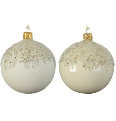 An assortment of 2 cream and wool white glass baubles with an enamel coating and cascading glitter bead design