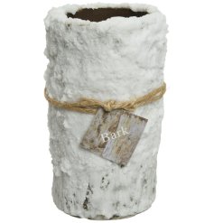 A beautiful snow covered bark candle. A stylish gift item and interior accessory this season. 