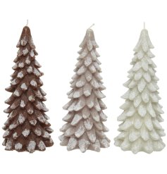 An assortment of 3 wax candle Christmas trees in neutral brown, grey and white colours. 