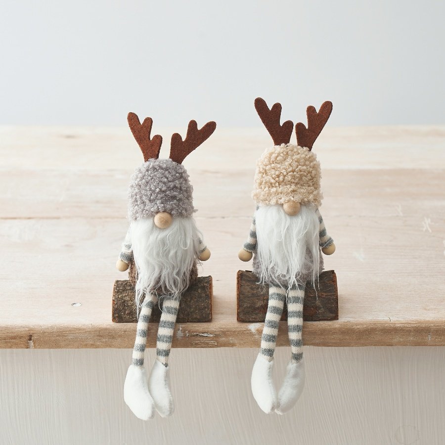 A chic sitting gonk figure with brown antlers. Complete with rustic log.