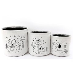 A charming assortment of 3 white canvas storage baskets