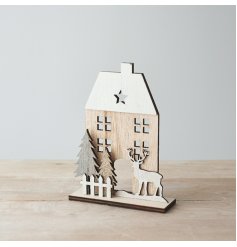 A charming wooden house decoration featuring cut out windows
