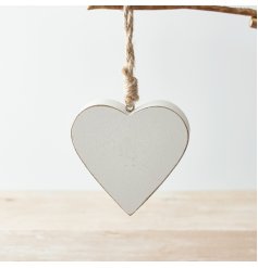 A small and simplistic wooden hanging heart in white