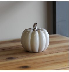 A small sleek, simple ceramic pumpkin