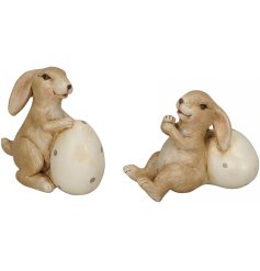 An assortment of 2 charming bunny ornaments with polka dot eggs.