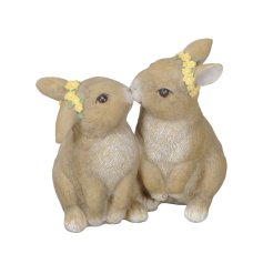 An adorable ornament featuring two kissing bunnies, each wearing a yellow flower crown. 