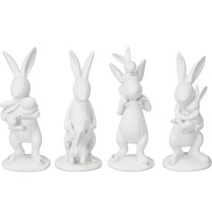 An assortment of 4 playful bunny ornaments, each with a white distressed finish.