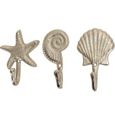 An assortment of 3 silver metal shell themed hooks. 