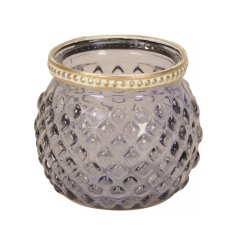 A pretty round t-light holder with a diamond ridged surface and decorative gold painted band.