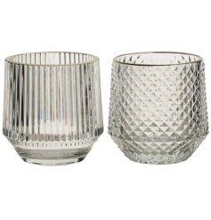 An assortment of 2 cut glass candle holders in stripe and diamond designs. A classic interior accessory 