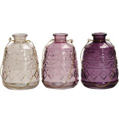 An assortment of 3 decorative glass lanterns in attractive purple colours. Each has a gold wire handle 