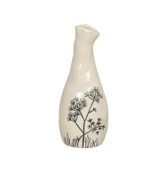 A beautiful and unique handmade ceramic vase with a glossy cream glaze and black painted floral design.