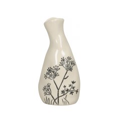 A unique handmade vase with a glossy cream finish and a beautiful engraved floral design.