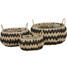 A set of 3 chunky woven planters with a natural and black zig zag design. Complete with handles and lining.
