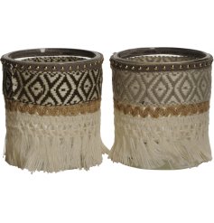 An assortment of 2 bohemian inspired candle holders. Beautifully detailed with fringing, gold studs and an aztec pattern