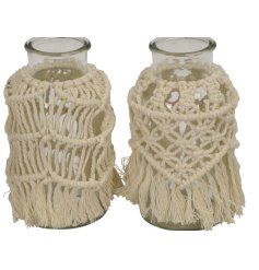 An assortment of 2 glass vases, each decorated with a boho macrame decoration. Complete with tassels. 
