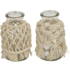 An assortment of 2 glass bottles, each with a unique macrame cover. A stylish vase and gift item.