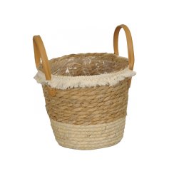A stylish woven basket with handles. Complete with a cream tassel trim. 
