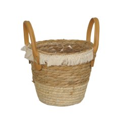 A rustic woven basket with a boho inspired tassel trim. Complete with handles and lining.