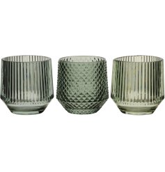An assortment of 3 beautifully coloured earth green glass candle holders in stripe and diamond finishes.
