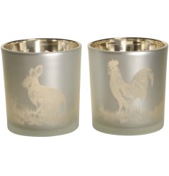 An assortment of 2 stunning matte silver candle holders with a gold bunny and chicken motif. 