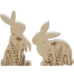 An assortment of 2 natural wooden bunny ornaments with a beautiful wild meadow and butterfly engraving.