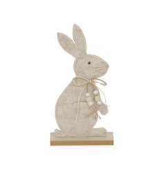 A super cute felt bunny perched upon a natural wooden base. Complete with a beaded double bow. 