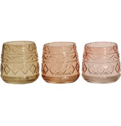 An assortment of 2 beautifully coloured glass candle holders with an aztec design.
