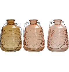 An assortment of 3 coloured glass lanterns. Each has a stylish aztec pattern and black handle.