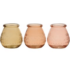 An assortment of 3 glass vases in a mix of 3 honey, peach and pink colours. Each has a unique and stylish aztec pattern.