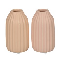 An assortment of 2 sleek ribbed vases is subtle peach and pink hues.