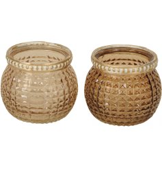 A mix of 2 honey coloured glass candle holders with a diamond pattern. 