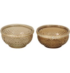 An assortment of 2 decorative glass dishes in rich golden tones.