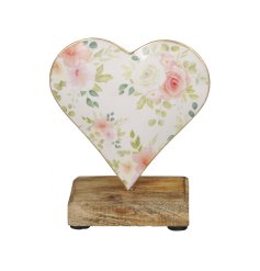 A pretty floral design heart with a delicate gold edge set upon a chunky wooden base. 