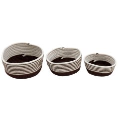 A set of 3 brown and white woven storage baskets. A stylish and practical item for the home.