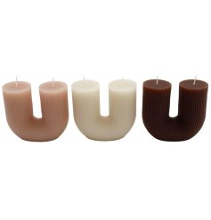 A mix of 3 arched rainbow candles in neutral colours. Each has two wicks. 