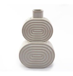 A stylish two tiered ceramic vase with a ribbed oval pattern and a white glazed finish. 