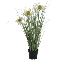 A black pot filled with fine quality artificial grass and pretty white and yellow flowers.