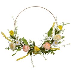 A stunning wire wreath dressed with an abundance of yellow, peach and white flowers.