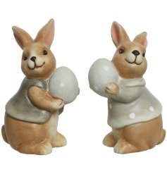 An assortment of 2 charming terracotta bunny ornaments with polka dot eggs and little jackets. 