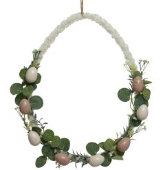 A unique egg shaped wreath wrapped with off white teddy fabric. Decorated with pastel coloured eggs 