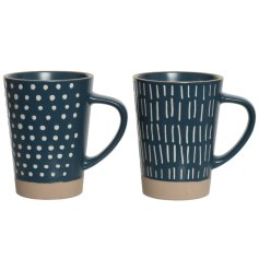 An assortment of 2 stoneware mugs each with a matte glaze and contemporary printed pattern. 