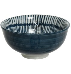 A glossy navy blue and white bowl with a tie dye inspired print.