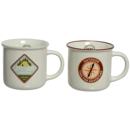 An assortment of 2 camping style mugs each with an adventure themed badge decoration 