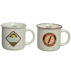 An assortment of 2 camping style mugs each with an adventure themed badge decoration 