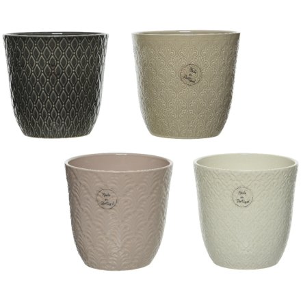 An assortment of 4 beautifully textured planters with floral and foliage themed patterns. The assortment includes grey, 