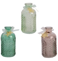 An assortment of 3 decorative glass bottles in rich green and brown hues. Each is decorated with a gold flower charm and