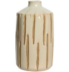 A cream handmade vase with a rustic debossed stripe pattern. 